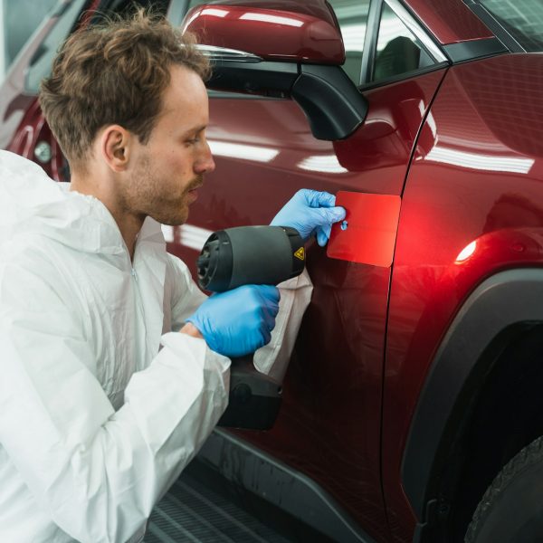 professional-auto-painter-matches-car-paint-color-with-lamp-and-samples.jpg